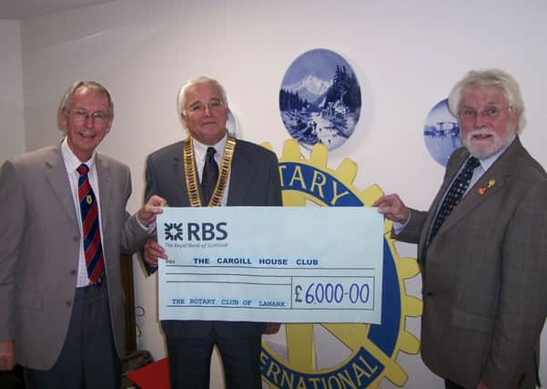 Thats grand...six grand, in  fact, to Kevan Carty (left) from Rotary President Bill Stewart (centre) and Harry Smith (Submitted pic)
