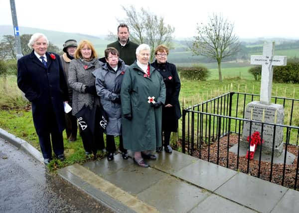 Paying respects...David Taylor and friends at the alternative war memorial in Elsrickle on Monday (Pic Lindsay Addison)