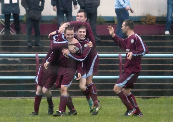 United's Chris Zok accepts the congratulations of his team mates after scoring the opening goal against Troon on Saturday.