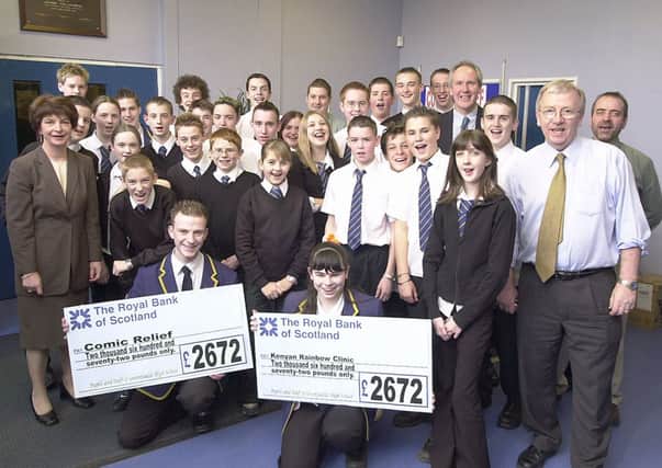 MONEY MATTERS: Greenfaulds High School pupils are pictured with cheques for cash they raised in 2003 for Comic Relief and the Kenyan Rainbow Clinic.