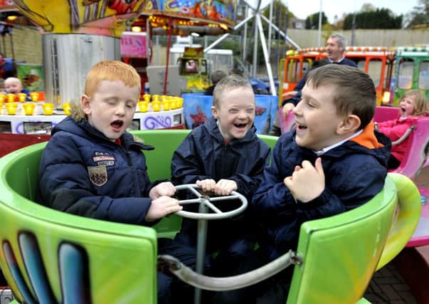 Spinning around...boys are having a brilliant laugh on the twisting teacups at Tesco funfair (Pic Lindsay Addison)