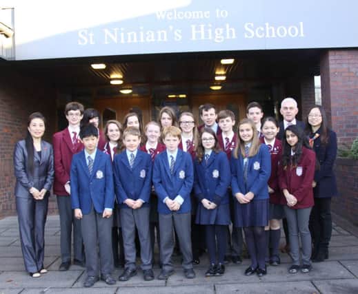 Head teacher John Docherty and (left) Ellena Zhou, the school's permanent teacher of Mandarin and (right) Tina Qin along with pupils from St Ninian's and Our Lady of the Missions pupils.