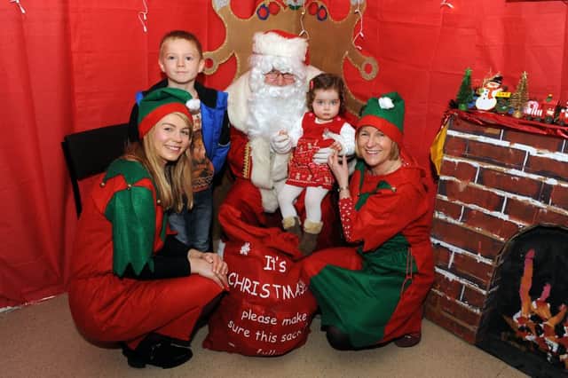 Santa and his elves with Lucy Dale age 21months and Gregor Ingleby age 8
