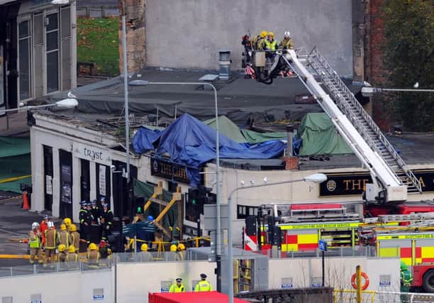 Rescue staff work tirelessly to make the building safe before removing the helicopter.
