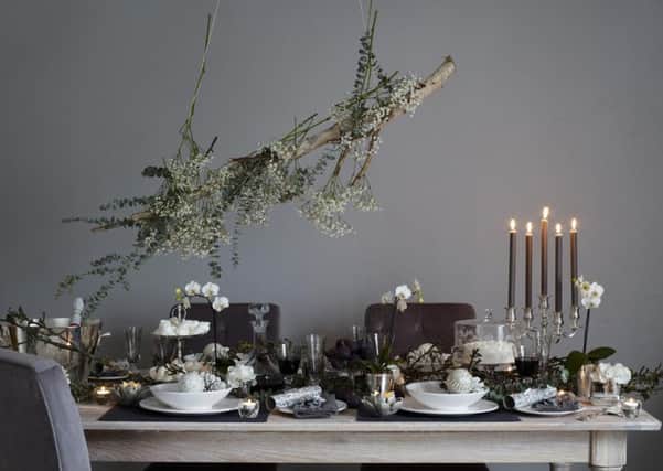 WHITE MAGIC. Undated Handout Photo of Amalfi dinner plate, £14; bowl, £19; Antoinette glass babule, £6 each, Silver heart bauble, £5 each. Emma tealight holder, £18, Brissi. See PA Feature INTERIORS Festive Tables. Picture credit should read: PA Photo/Handout. WARNING: This picture must only be used to accompany PA Feature INTERIORS Festive Tables.