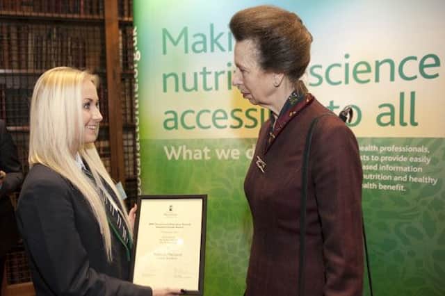 Rebecca received her award from Princess Anne