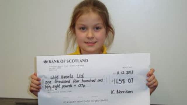P6 Ilona Bladworth presents the Wildhearts Micro Tyco charity cheque.