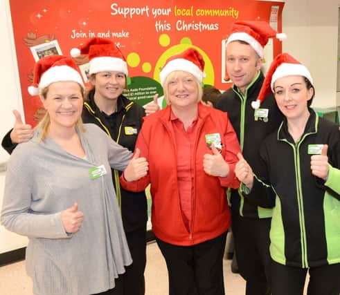 Lorraine MacDonald is pictured (centre) with some of her Asda colleagues.