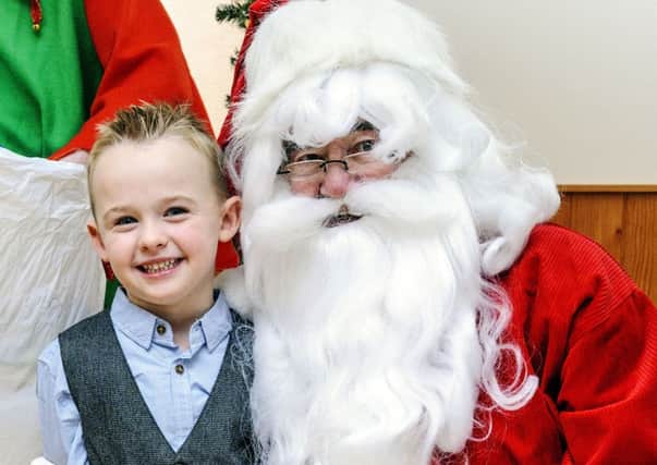 Have you been good? The angelic face on this wee one from St Mary's Primary in Lanark would certainly make you believe so, Santa! (Picture by Andrew Wilson)