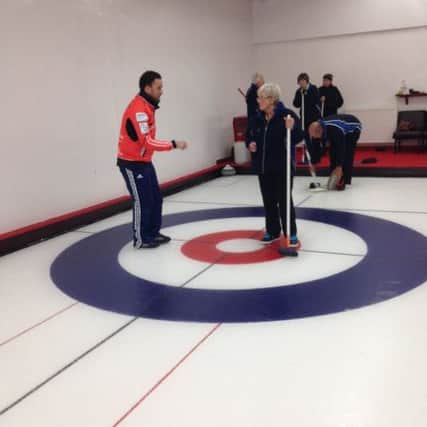 Coaching at the Greenacres Curling Rink.