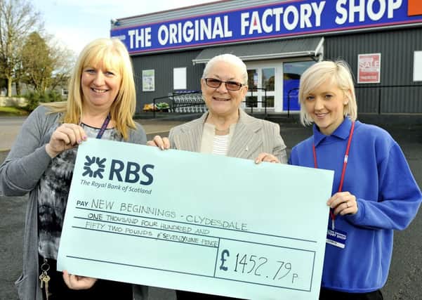 Cheque please...Mary McLellan (centre) receives the cheque for Original Factory staff