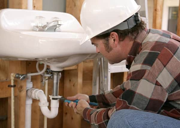 A Generic Photo of a plumber working in a bathroom. See PA Feature HOMES Homes Column. Picture credit should read: PA Photo/JupiterImages Corporation. WARNING: This picture must only be used to accompany PA Feature HOMES Homes Column.