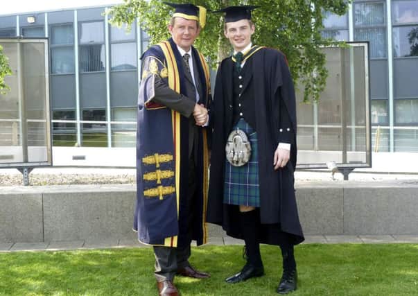 Marvel man...Scott Brindley with University of Bolton Vice Chancellor Professor George Holmes
