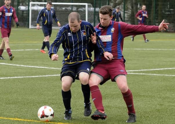 ACTION MEN:These players are in the thick of the action during the Condorrat v Hillfoots amateur match on Saturday which saw Condorra come away with a 5-4 victory.