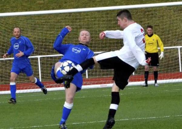 Battle for the ball...Carluke Rovers player collides with Maryhill defender