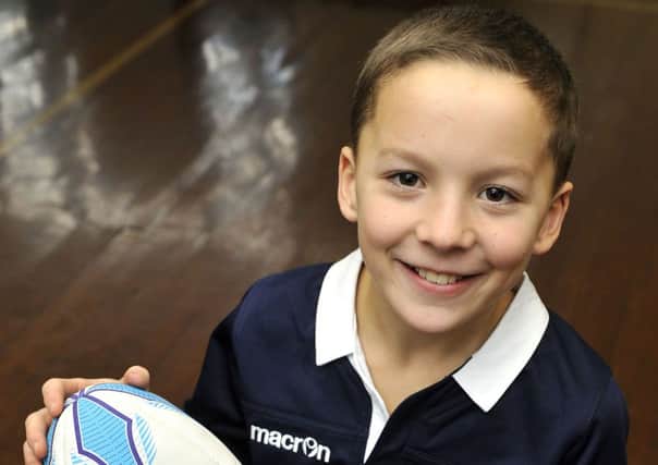 Mascot...Andrew Wight (11), of Crawford Primary School, was on the ball as a rugby mascot (Pic Lindsay Addison)