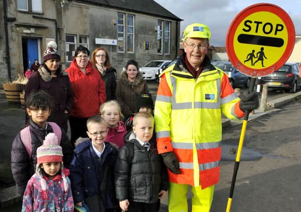 Please stay...lollipop man David Nimmo with pupils and parents