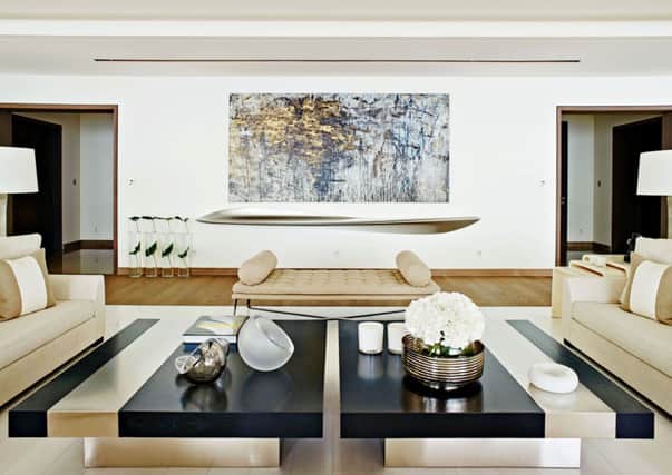 HOPPEN Undated Handout Photo of artwork and a dramatic sculptural shelf resin. The symmetry draws the eye in a white living area with its accents of taupe. Image in book Kelly Hoppen Design Masterclass. See PA Feature INTERIORS Designers. Picture credit should read: PA Photo/Handout. WARNING: This picture must only be used to accompany PA Feature INTERIORS Designers.