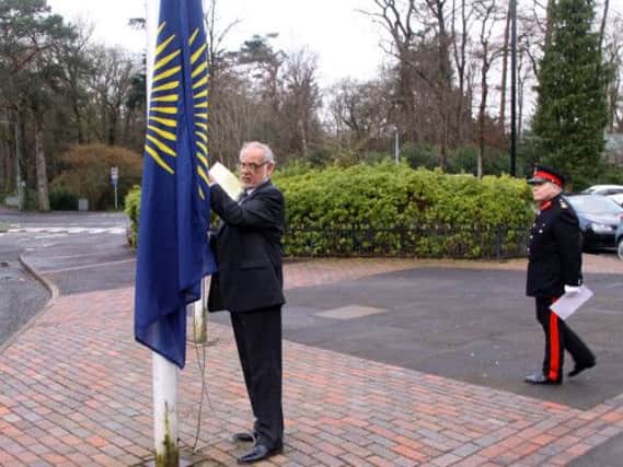 Provost Carmichael hoists the flag as the Lord Lieutenant looks on.