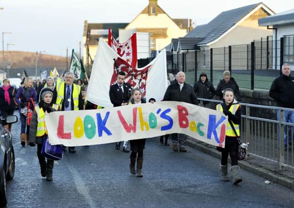 On the march...pupils, parents and staff marched to their new school in Coalburn on their first day in the building (Pic Lindsay Addison)