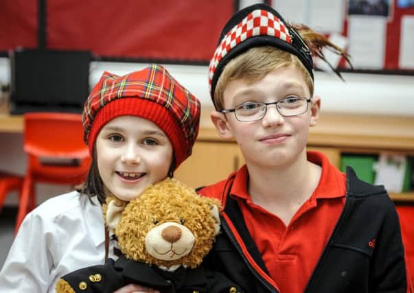 Bear with us...pupils show off their tartan fashions and their McTeddy (Pic Andrew Wilson)