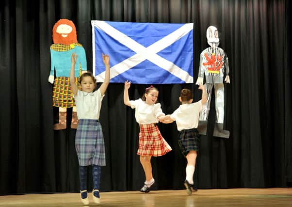 Flying the flag...pupils perform at their Scottish celebration in Carstairs Primary School (Pic Lindsay Addison)