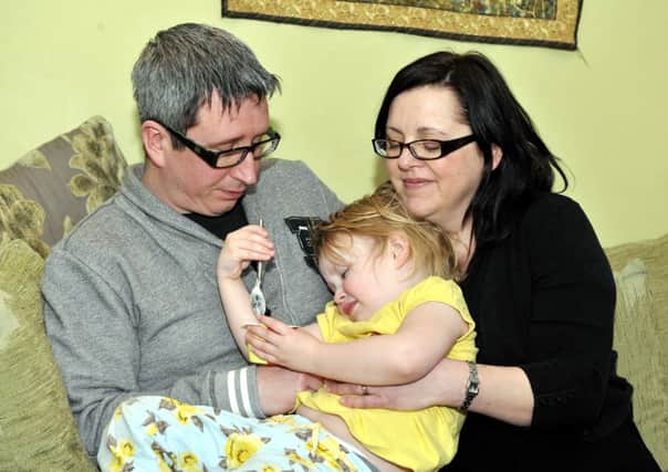 Family fears...Alasdair and Nikki with their daughter Charlotte, who has a very rare eating compulsion (Pic Lindsay Addison)