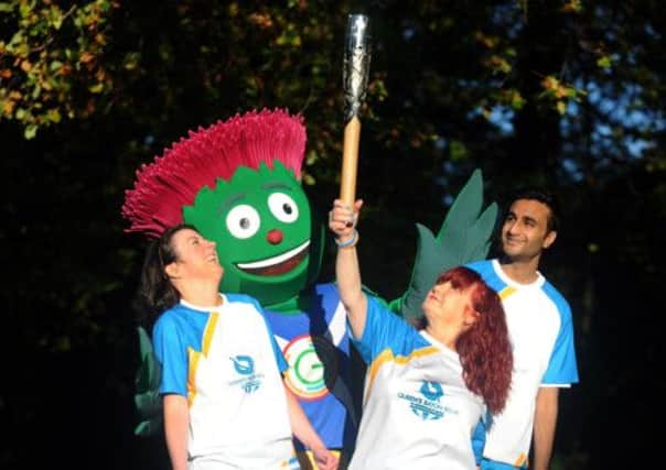 Games representatives Julie McElroy, Izzy Conway and Aamir Mehmood join Glasgow 2014 mascot Clyde in a pose at the southsides own Pollok Park . Photo by Bill Fleming.