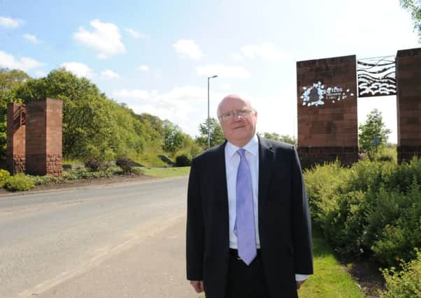 Tom Clarke MP at the entrance of Gartcosh Industrial Park