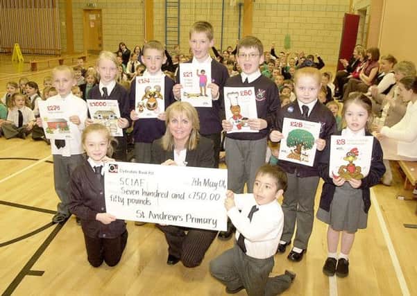 RAISING FUNDS:Pupils of St Andrews  Primary School in Cumbernauld hand over a cheque for £750 to SCIAF in 2004.