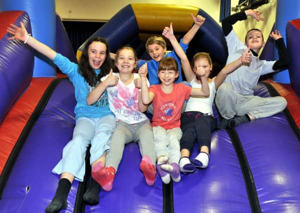 On the slide...big cheers from some of the youngsters taking part in the micro-fit inflatable assault course (Pic Lindsay Addison)