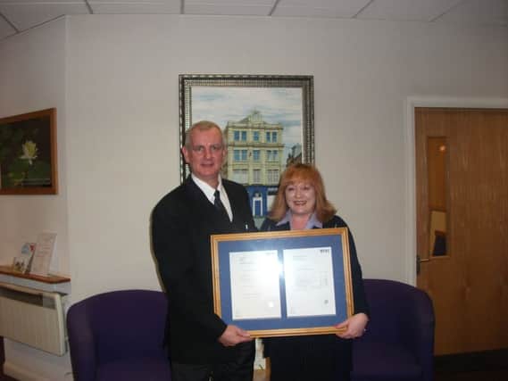 Jim Lee, principal funeral director, presenting Anne with her certificate.