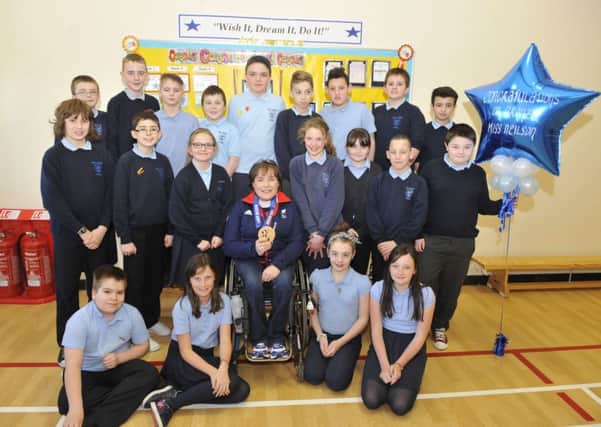Medal marvel...Aileen Neilson with pupils at Bent Primary (Pic by Lindsay Addison)