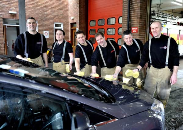 Shining examople....to the  Scottish Fire and Rescue Service are these firefighters and their colleagues at the spring sponsored carwash event for charity close to their hearts and to those members of the public they serve (Pic Lindsay Addison)