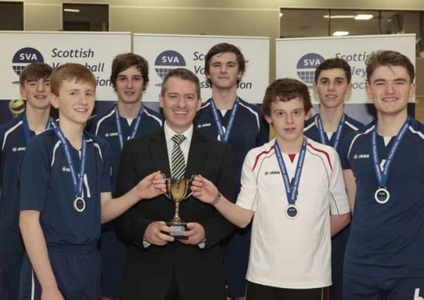 High class...the victorious Carluke squad members are pictured with cup and their head teacher Andy Smith (Submitted pic)