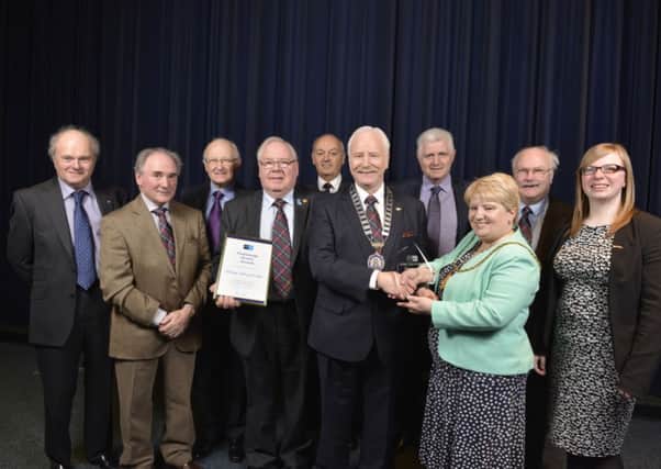 Roll of honour....continues for Carluke Rotary Club as they received an award from nominator Eileen Logan and Councillor Lynsey Hamilton which President Archie M Ralston and fellow members collected (Pic David Gordon)