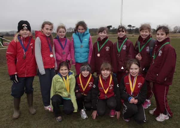 Team triumph...P6 girls winners Biggar Primary (front) with runners-up Lanark and third-placed St Athanasius (Pic Helen Barrington)