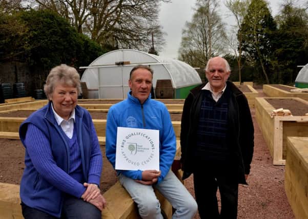 Accreditation...Trust Chairman Sylvia Russell, Horticultural Education Officer Chris Helm and Lanark in Bloom's Ernest Romer with the RHS certificate. (Pic by Rodger Price)