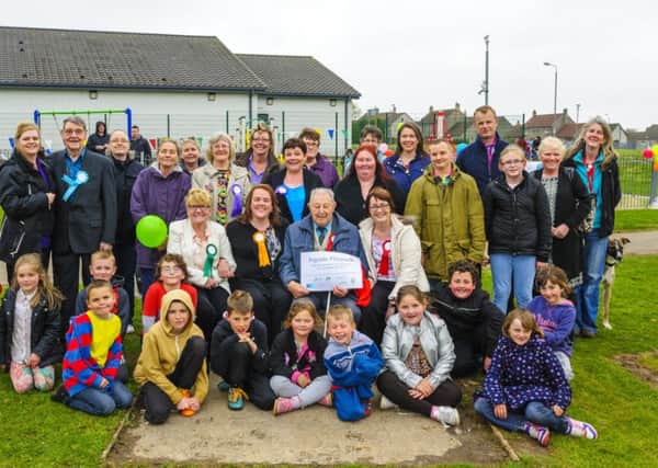 Very popular...families gather for the opening of Rigside's new playpark (Pic by Andrew Wilson)