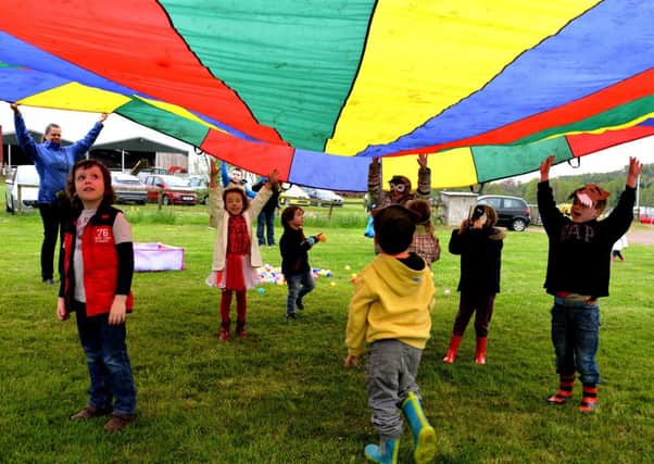 A rainbow of colour...and fun was parachuted in for the youngsters at Overton Farm's Blossom Day in Crossford (Pic Rodger Price)