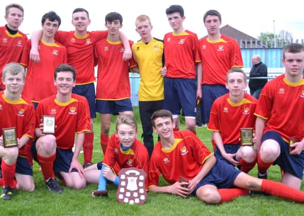 Cardinal Newman High football team with the Lanarkshire Schools trophy after beating Abronhill in the final at Wishaw.