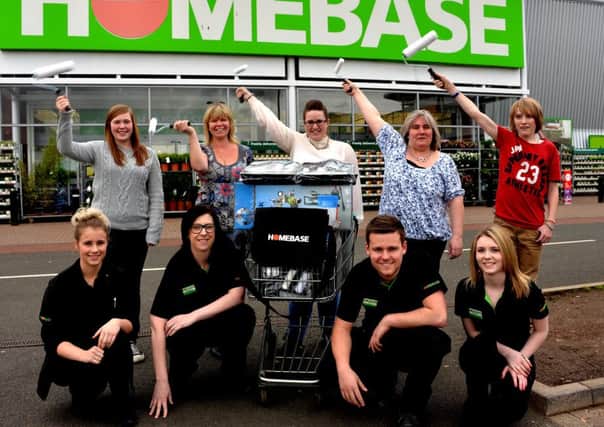 Ready to work...Karen Gillon with her squad are given paint and rollers by Homebase in Lanark ( 

Pic by Rodger Price)