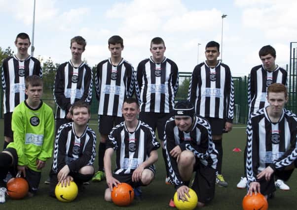 Some of the New College Lanarkshire students with the new strips and equipment.