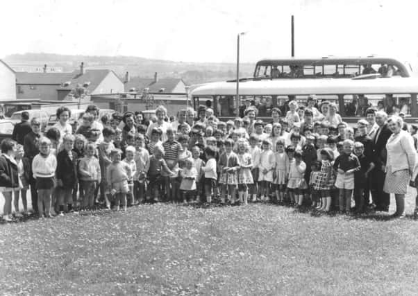 KIDS' OUTING: Youngsters of Kildrum Parish Church Sunday School prepare to set off on their annual outing. Do you know which this took place?