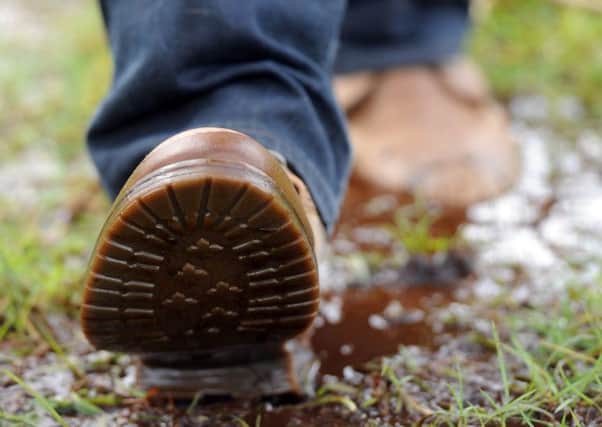 TS News. 05/04/2012. Walking boots walkers ramblers muddy boots puddles. Arthur's Seat