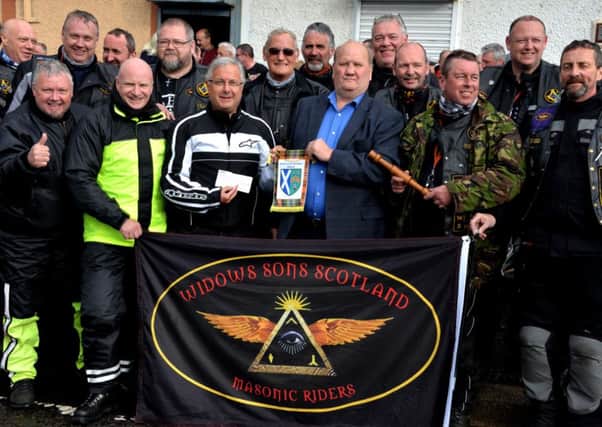 Brothers in leather...the Widows Sons with Alex Thomson (centre, right) as he presents the cheque to Bro David Reid (Pic Rodger Price)