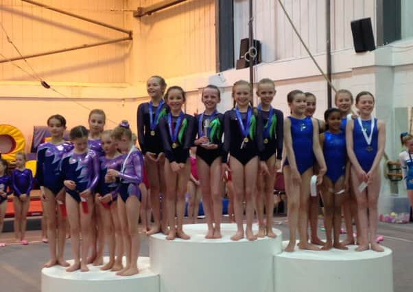 WINNERS: Young gymnasts pose on the podium with their medals
