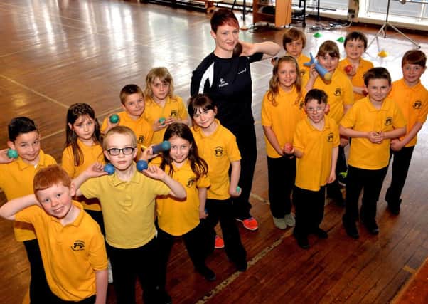 Putt it there...Commonwealth Games competitor Kirsty Yates shared her shot put techniques with Carnwath Primary School children (Pic Rodger Price)