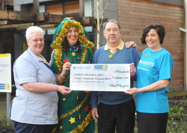 Marie Curie Hospice. Lesley McChrystal and her dad Henry McGhie handing over a cheque in 2011