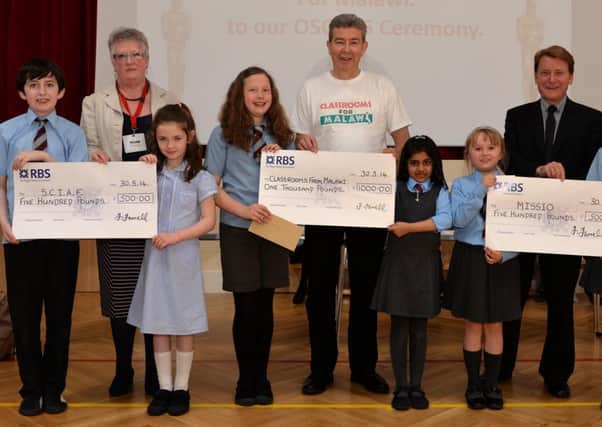 Cheque it out...St Athanasius pupils handed over four cheques worth a total of £2500 (Pic Rodger Price)